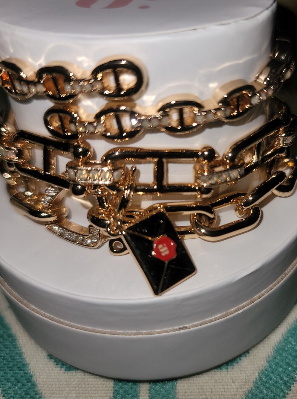 BP 2026 Summer Stacks Gold Bracelet Stack with Envelope Charm. Founder's Letter